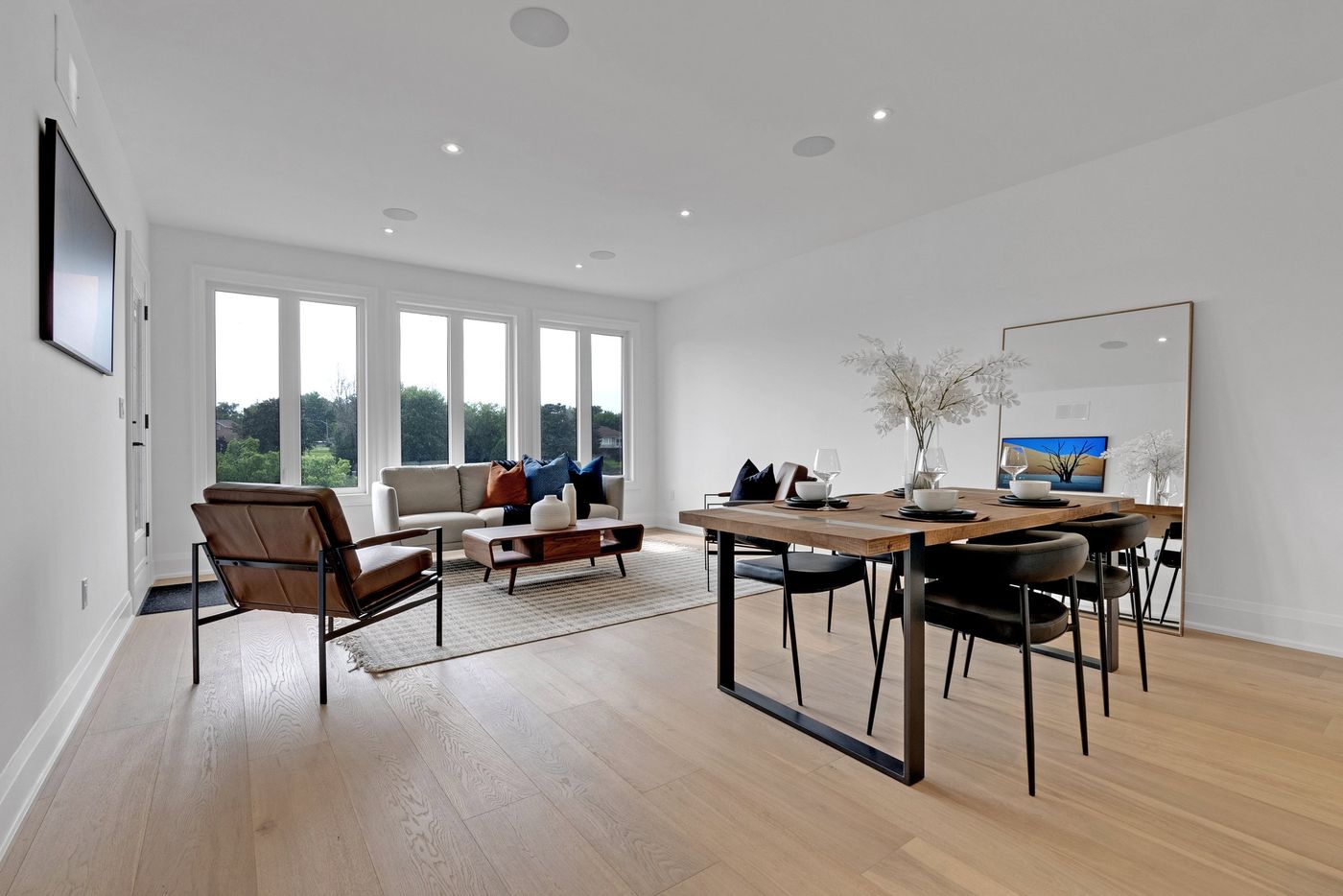 Living and dining room with large rear windows