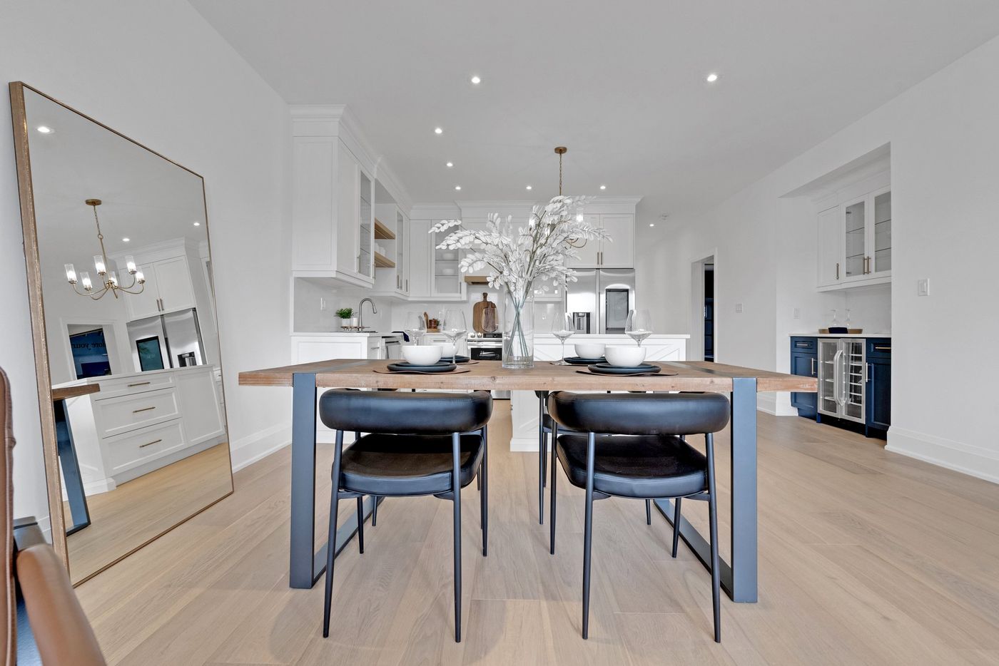 Dining area with kitchen and beverage centre beyond