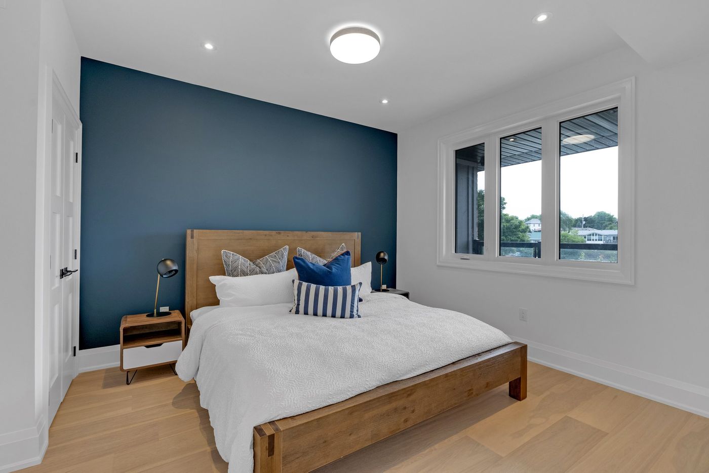 Primary bedroom with navy accent wall