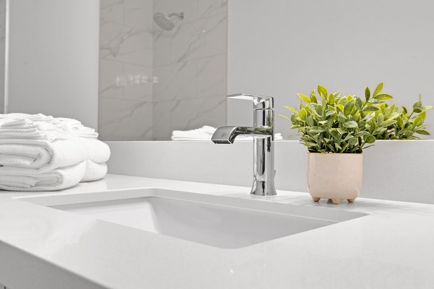 Bathroom vanity detail with chrome faucet