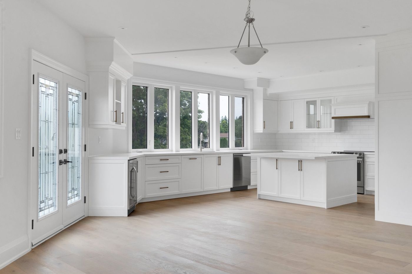 Kitchen with wall of windows and garden doors