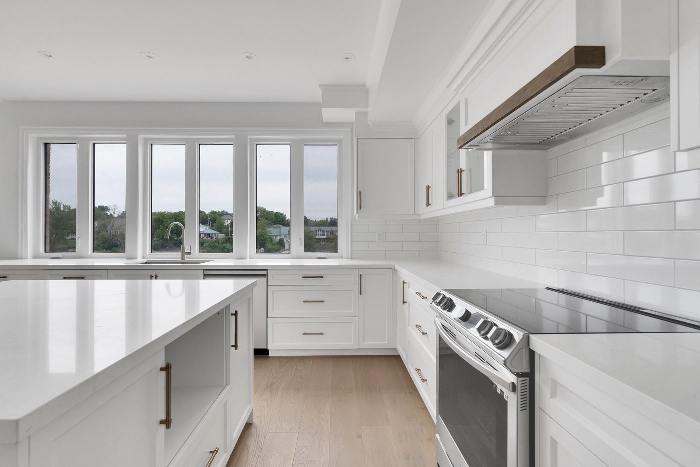 Kitchen range wall with subway tile and window wall to the river