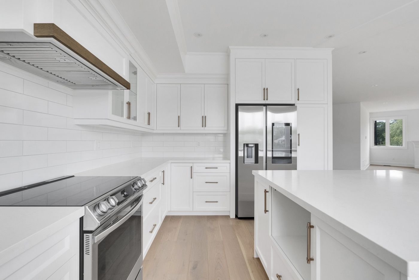 Kitchen with stainless appliances and tall pantry cabinets